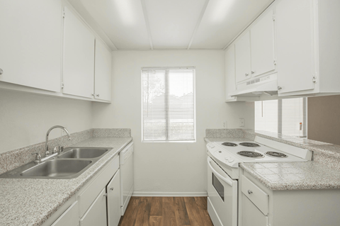 a kitchen with white cabinets and white appliances